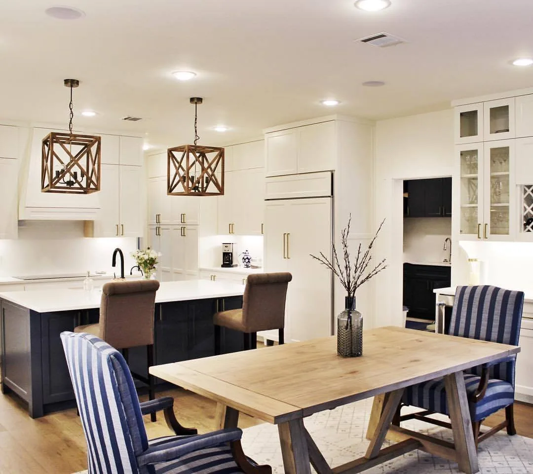 White kitchen with lantern pendants and dining table
