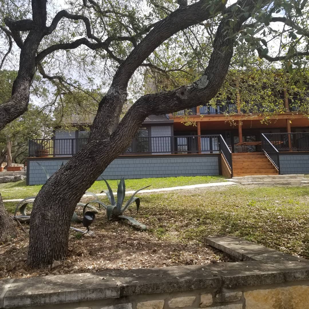 New build home behind a live oak tree